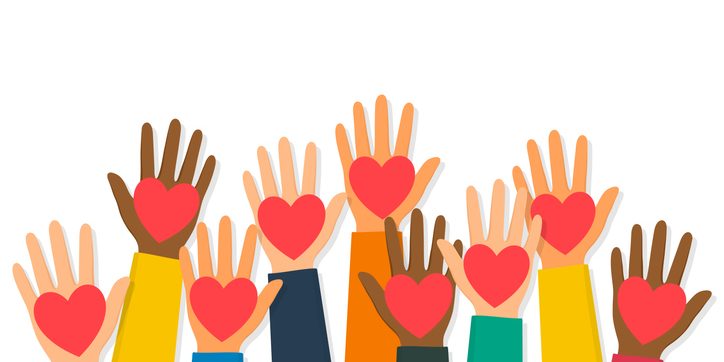Charity, volunteering and donating concept. Raised up human hands with red hearts. Children’s hands are holding heart symbols